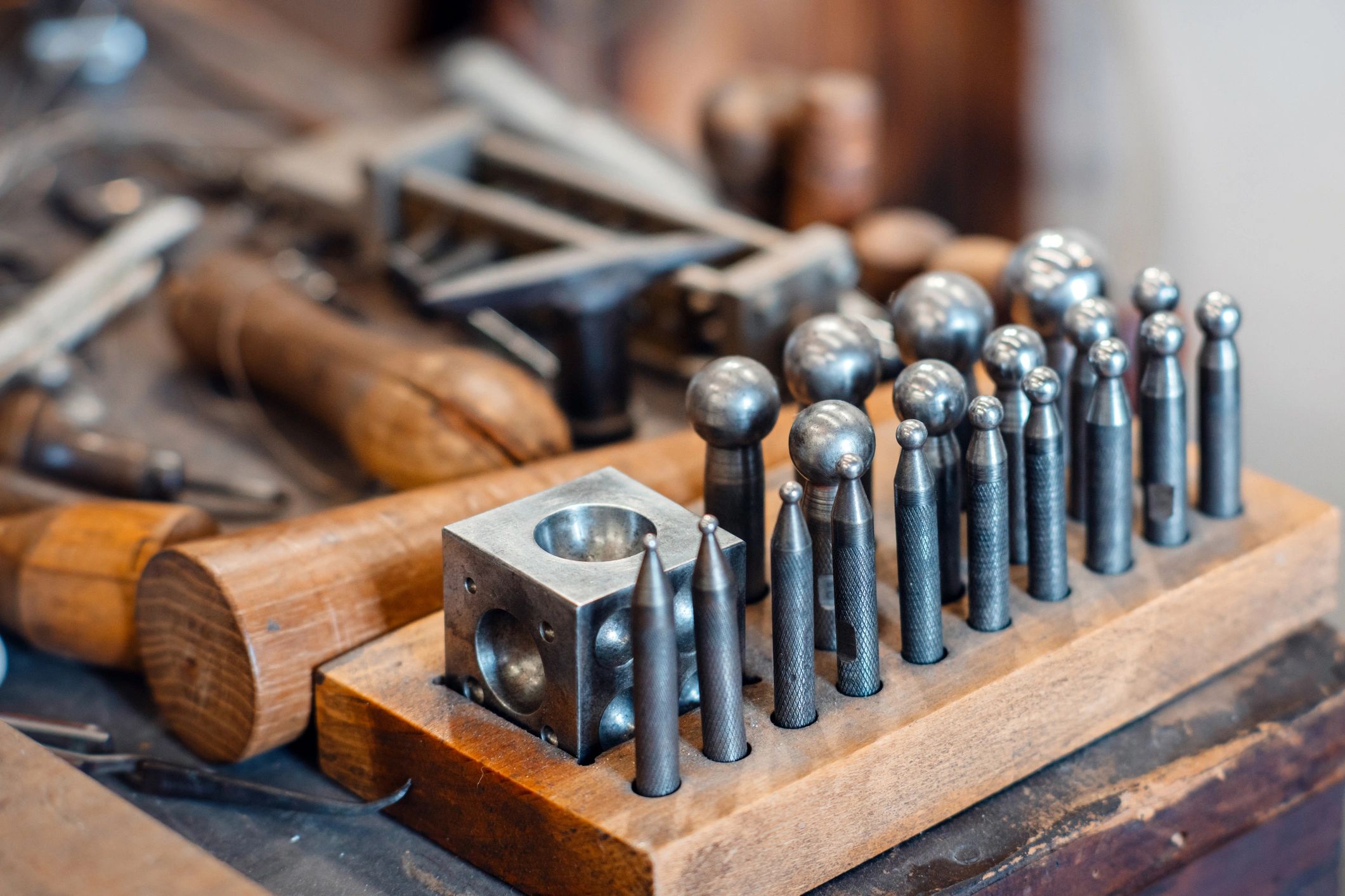 Goldsmith tools arranged on a metalworking bench